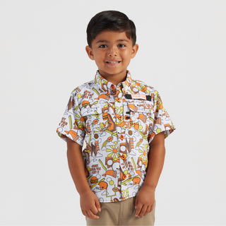 Child wearing a patterned shirt on a plain background