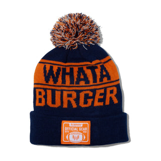 Navy and orange beanie with 'WHATA BURGER' text and pom-pom on a white background