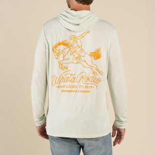 Person wearing a light-colored hoodie with a graphic of a horse and text on the back against a beige background