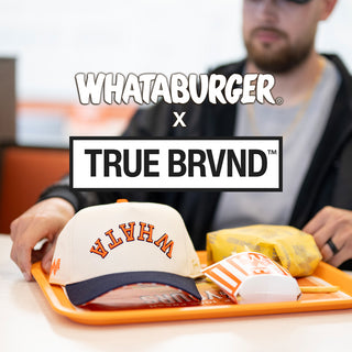 View tray with Whataburger food and True Brvnd Whata hat. Reads Whataburger x True Brvnd.