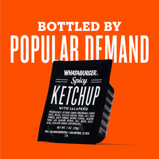 Black ketchup packet with white text on an orange background