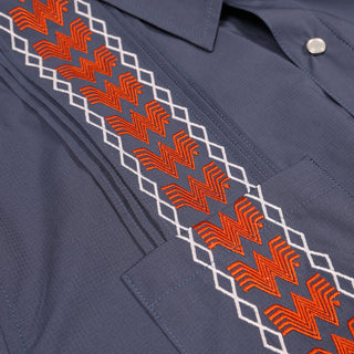 Navy shirt with orange and white geometric embroidery on a collar