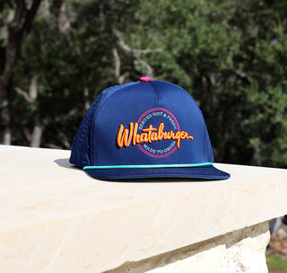 view navy neon sign staunch hat on limestone with trees in the background.