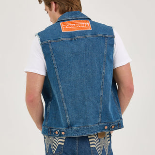 Full back view of the Wrangler® x Whataburger® Men's Cut-Off Vest – A male model stands with his back to the camera, showcasing the Whataburger® logo patch on the back of the Wrangler® x Whataburger® Men's Cut-Off Vest, with matching denim jeans featuring the Flying W embroidery.