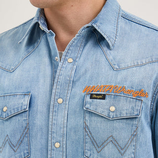 Close-up of the chest details on the Wrangler® x Whataburger® Men's Western Shirt – A detailed view of the Wrangler® x Whataburger® Men's Western Shirt, highlighting the pearl snap buttons, "WHATAWrangler" embroidery, and Wrangler® logo tag on the left chest pocket.