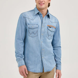 A male model wearing the Wrangler® x Whataburger® Men's Western Shirt – A male model wears the Wrangler® x Whataburger® Men's Western Shirt styled with tan jeans, capturing a classic Western look.