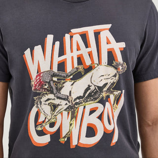 A detailed view of the front design on the Wrangler® x Whataburger® Cowboy Graphic Black T-Shirt. The illustration of the cowboy mid-ride on a bucking bronco is emphasized, along with the distressed typography spelling "WHATA COWBOY."