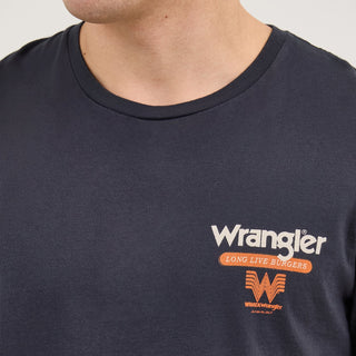 A close-up of the front of the Wrangler® x Whataburger® Cowboy Burgers Black T-Shirt, showing the chest print. The design features the Wrangler® and Whataburger® logos with "Long Live Burgers" in bold Western-style lettering.