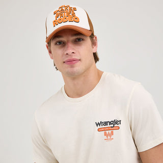 A casual shot of the model wearing the Wrangler® x Whataburger® Cowboy Burgers White T-Shirt, styled with a brown mesh trucker hat, reinforcing the Western aesthetic.