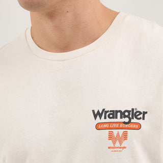 A detailed view of the small Wrangler® and Whataburger® logo on the left chest area of the shirt. The logo includes the iconic Flying W and "Long Live Burgers" in orange and black print.