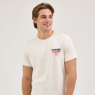 A side-angle view of the model showcasing the Wrangler® x Whataburger® Cowboy Burgers White T-Shirt’s back print, emphasizing the retro color scheme and Western-inspired theme.