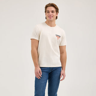 A full-body image of the model wearing the Wrangler® x Whataburger® Cowboy Burgers White T-Shirt, classic denim jeans, and cowboy boots, giving a complete look at the outfit's Western inspiration.