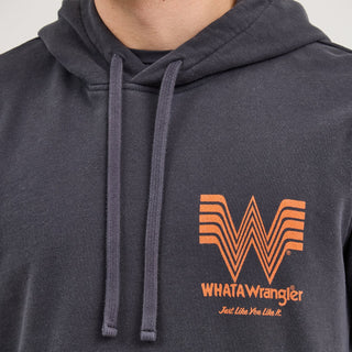 Close-up of the Wrangler® x Whataburger® Faded Black Hoodie’s chest design, worn by a male model. The hoodie displays the Flying W logo and "WHATAWrangler" text in orange on the left side of the chest.