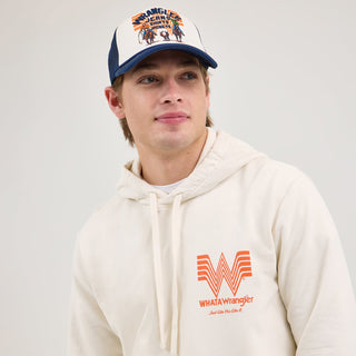 Front view of the Wrangler® x Whataburger® Cream Hoodie – A male model wears the Wrangler® x Whataburger® Cream Hoodie, featuring a soft cream-colored fabric with an orange Flying W logo and "WHATAWrangler" text on the left chest.