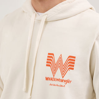 Close-up of the chest details on the Wrangler® x Whataburger® Cream Hoodie – A zoomed-in look at the left chest design, highlighting the Flying W logo, "WHATAWrangler" branding, and "Just Like You Like It" slogan printed in orange.