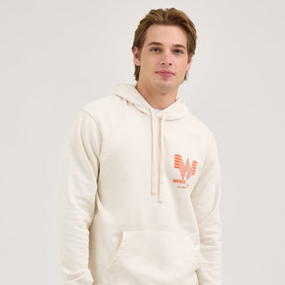 A male model wearing the Wrangler® x Whataburger® Cream Hoodie – A male model wears the Wrangler® x Whataburger® Cream Hoodie styled with blue denim jeans for a relaxed Western look.