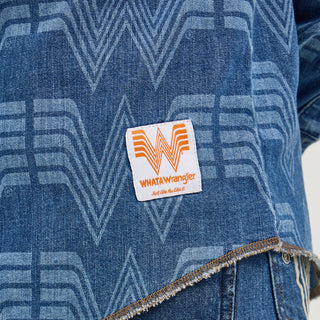 Close-up of the hem on the Wrangler® x Whataburger® Men's Western Print Shirt – A zoomed-in look at the lower portion of the shirt, highlighting the Flying W pattern, a Whataburger® patch near the hem, and a frayed, raw-edge design.