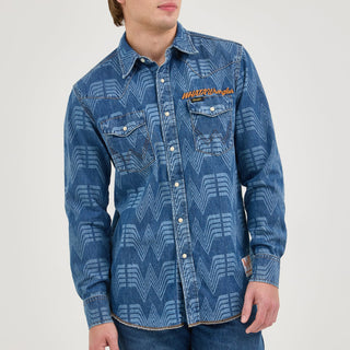 A male model wearing the Wrangler® x Whataburger® Men's Western Print Shirt – A male model wears the Wrangler® x Whataburger® Men's Western Print Shirt, styled with denim jeans. The shirt's Western-inspired design, including the snap buttons and bold pattern, is fully displayed.