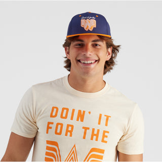 Man wearing a cap and t-shirt with text on a plain background