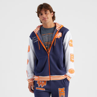 Person wearing a navy and white hoodie with orange accents on a white background
