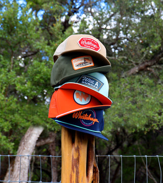 Stacked Whataburger hats on a post. Click to view all hats. 