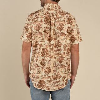 Person wearing a patterned shirt with a beige background