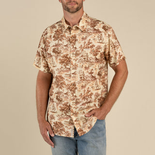 Man wearing a patterned shirt with a beige background