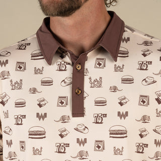 Close-up of a patterned shirt with logos and graphics on a beige background