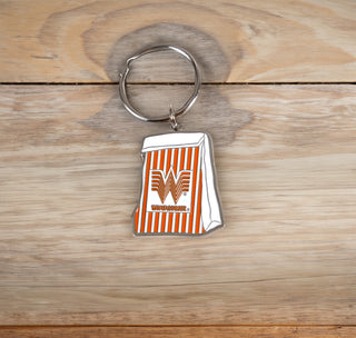 View Orange and White Bag Metal Keychain on woode table