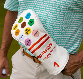 view man holding golf club with whataburger driver head cover.