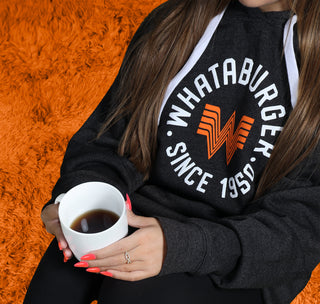view model sitting with a cup of coffee wearing the charcoal sportiqe hoodie