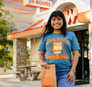 view model wearing taquito sunrise tee standing outside of a whataburger while holding a to-go bag