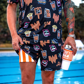 view model next to a pool wearing whataburger and chubbies swim trunks
