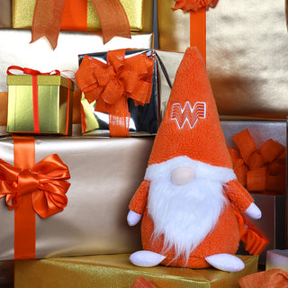 view plush holiday gnome sitting on wrapped presents