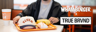 View tray with Whataburger food and True Brvnd Whata hat. Reads Whataburger x True Brvnd.