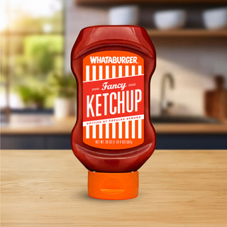 Whataburger Fancy Ketchup bottle on a wooden surface with a blurred kitchen background