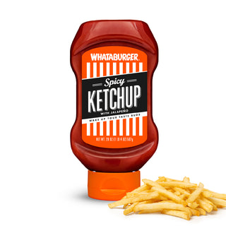 Whataburger Spicy Ketchup bottle with a pile of fries on a white background