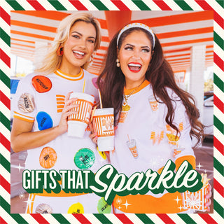 Promotional banner for 'Gifts That Sparkle' with two women holding Whataburger drinks and fries.