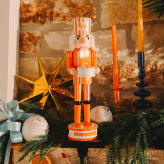 Decorative nutcracker with 'Whataburger' branding on a festive background with Christmas decorations.