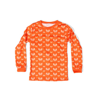 Orange children's pajama shirt with white Whataburger pattern on a white background