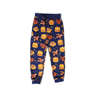 Navy blue youth pajama pants with Whataburger breakfast pattern on a white background