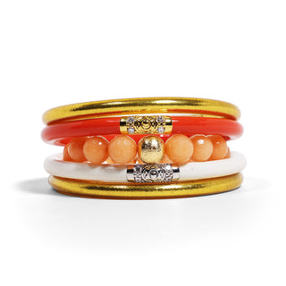 Stack of colorful bracelets with gold accents on a white background