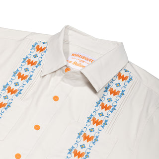 Close up of embroidered floral pattern on Light Floral Guayabera on white background