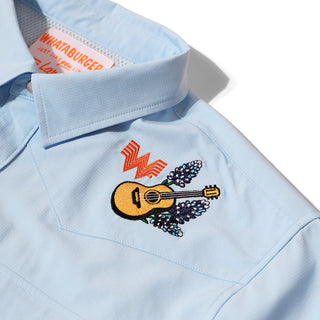 Light blue fishing shirt with Flying W logo, guitar and bluebonnet embroidery on a white background