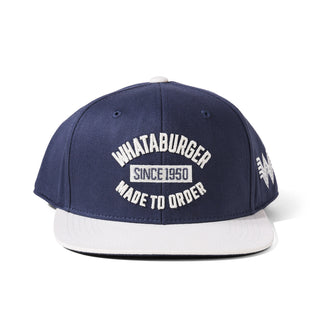 Navy blue and white cap with 'Whataburger' branding on a white background
