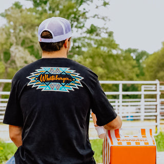 Person wearing a black t-shirt with a Whataburger logo outdoors