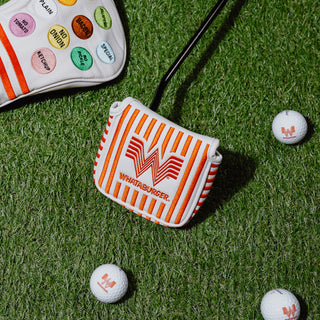 Striped Mallet Putter Cover with Whataburger logo on grass with golf balls.